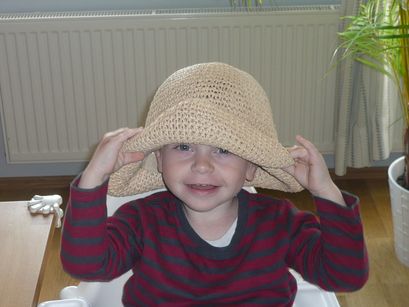 Having fun with Mum's hat.