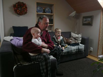 The men of the family watching TV. 